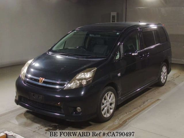 A grey JDM sports car speeding down a highway at night.