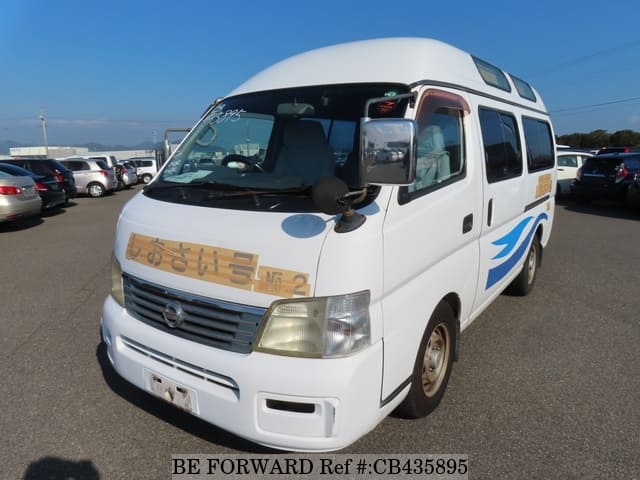 A grey JDM sports car speeding down a highway at night.