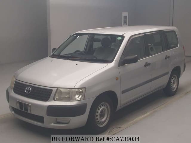 A grey JDM sports car speeding down a highway at night.