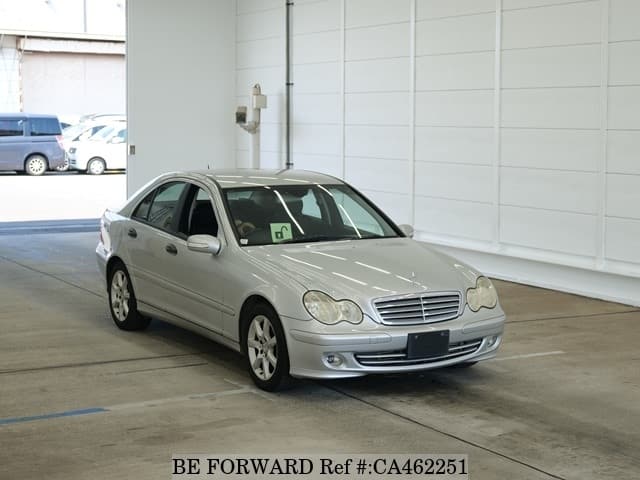 A grey JDM sports car speeding down a highway at night.