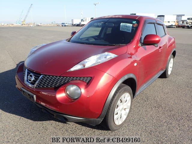 A grey JDM sports car speeding down a highway at night.