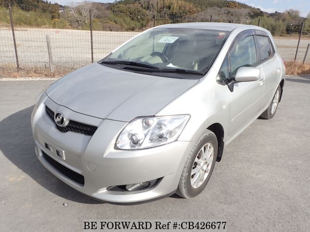 A grey JDM sports car speeding down a highway at night.