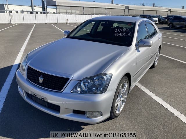 A grey JDM sports car speeding down a highway at night.