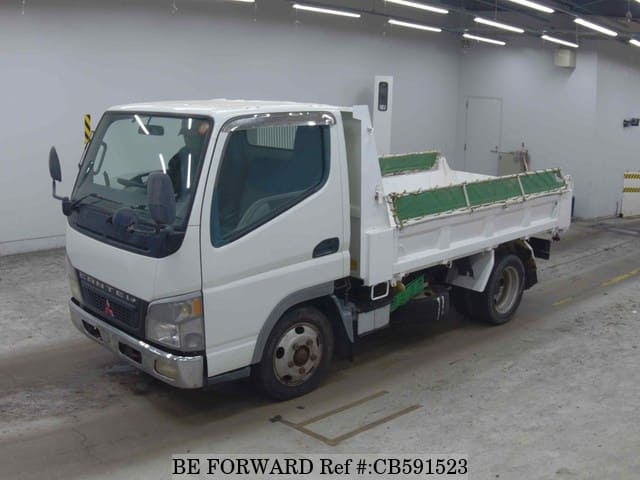 A grey JDM sports car speeding down a highway at night.