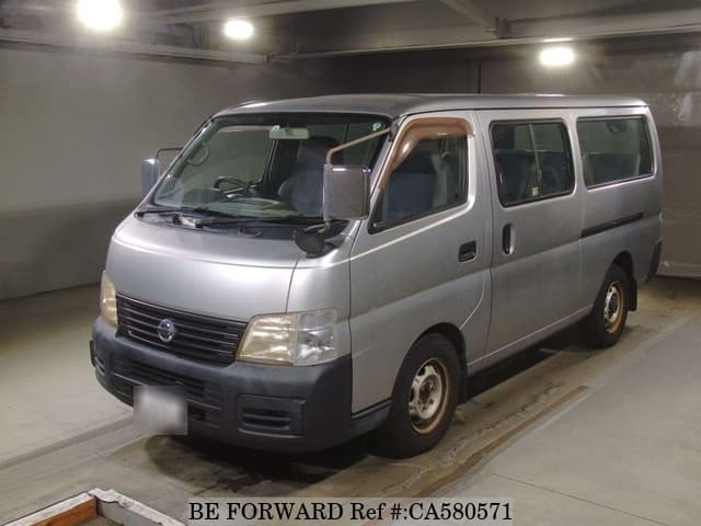 A grey JDM sports car speeding down a highway at night.