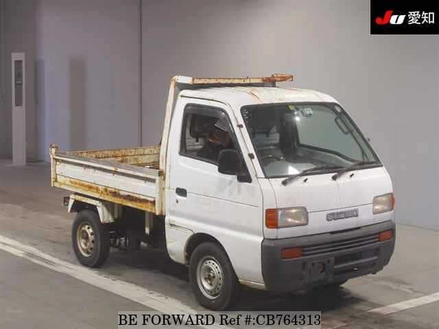 A grey JDM sports car speeding down a highway at night.