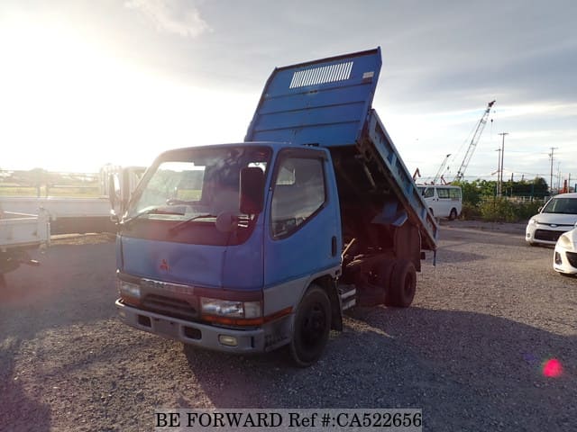 A grey JDM sports car speeding down a highway at night.