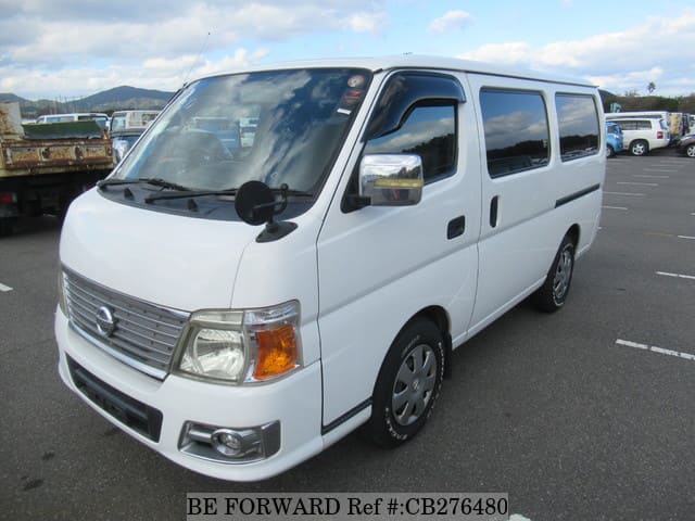 A grey JDM sports car speeding down a highway at night.