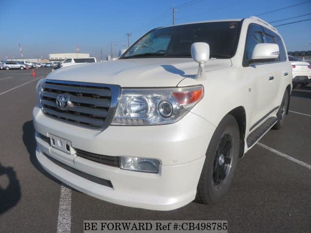 A grey JDM sports car speeding down a highway at night.