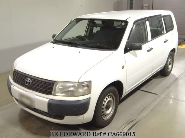 A grey JDM sports car speeding down a highway at night.