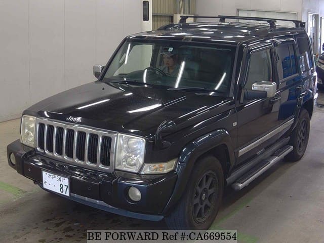 A grey JDM sports car speeding down a highway at night.
