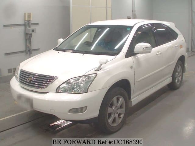 A grey sports car speeding down a highway at night.