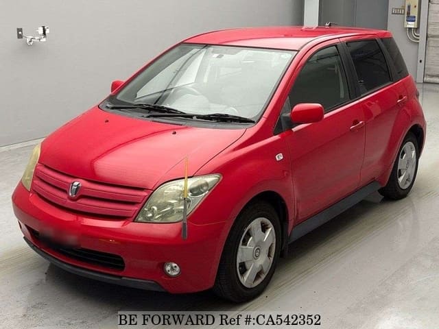 A grey JDM sports car speeding down a highway at night.