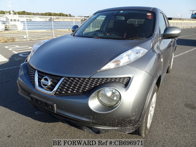 A grey JDM sports car speeding down a highway at night.