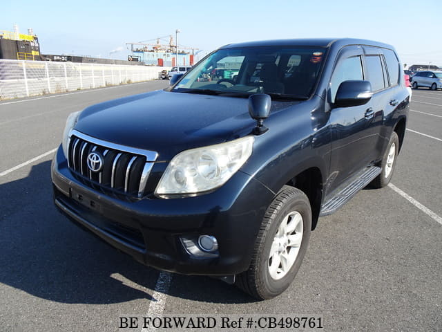 A grey JDM sports car speeding down a highway at night.