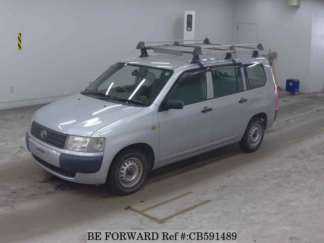 A grey JDM sports car speeding down a highway at night.
