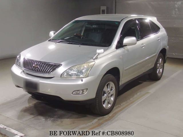 A grey JDM sports car speeding down a highway at night.