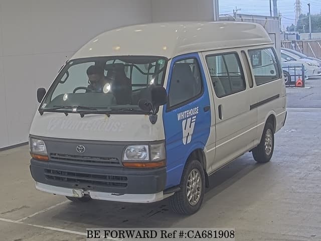 A grey JDM sports car speeding down a highway at night.