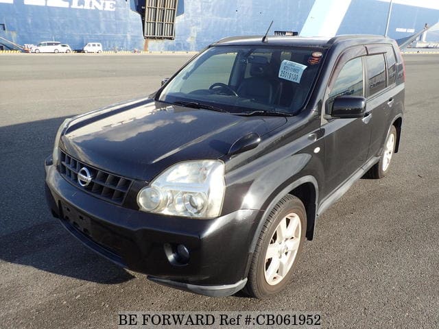 A grey JDM sports car speeding down a highway at night.