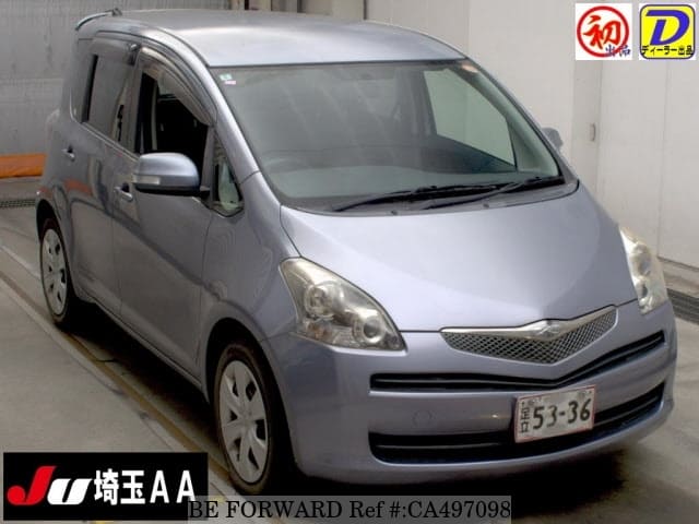 A grey JDM sports car speeding down a highway at night.