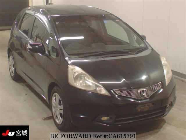 A grey JDM sports car speeding down a highway at night.