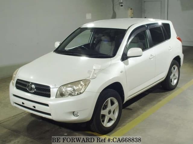 A grey JDM sports car speeding down a highway at night.