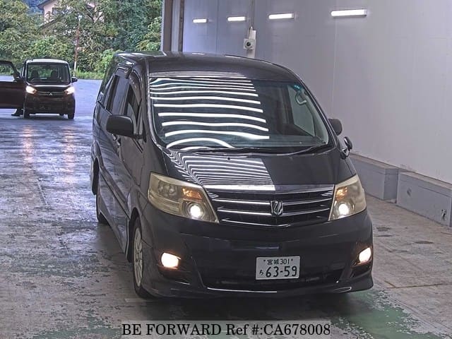 A grey JDM sports car speeding down a highway at night.