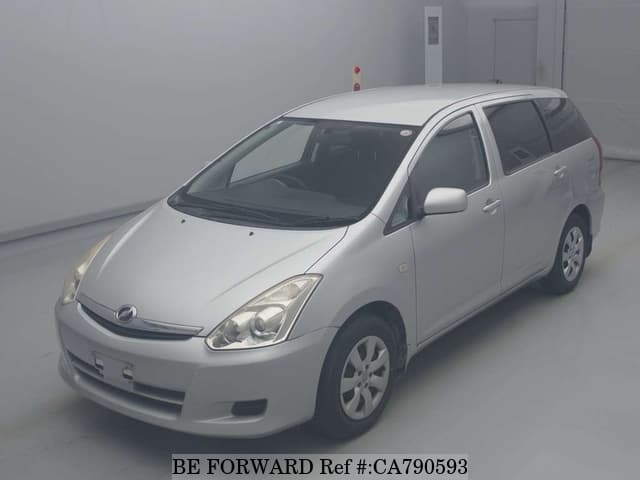 A grey JDM sports car speeding down a highway at night.