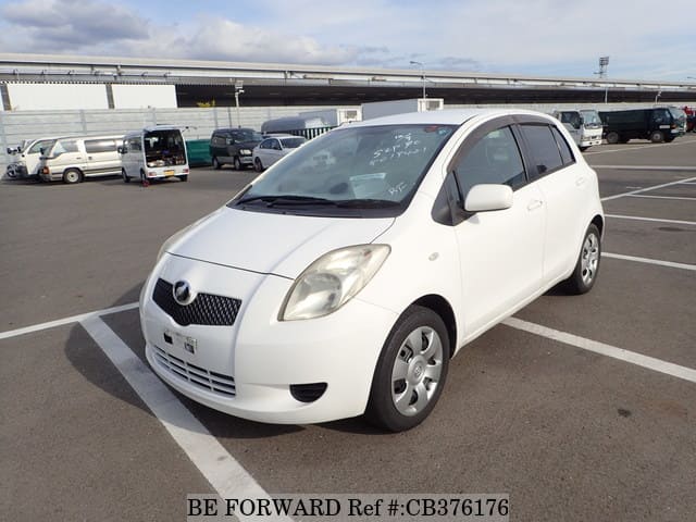 A grey JDM sports car speeding down a highway at night.