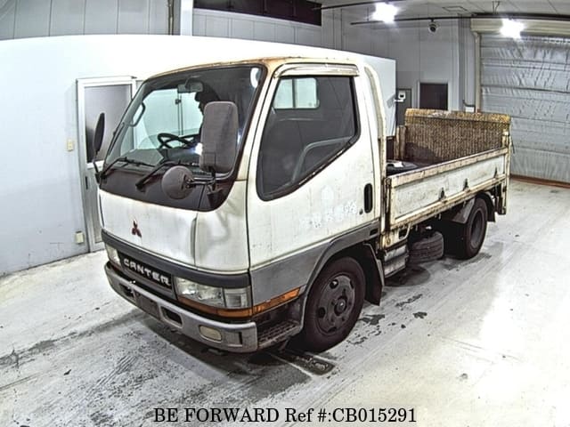 A grey JDM sports car speeding down a highway at night.