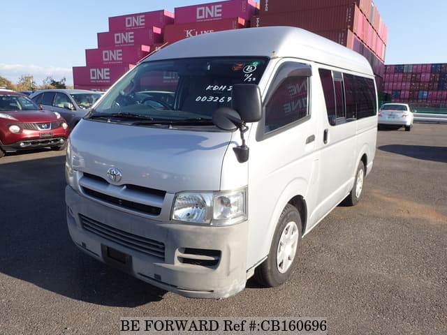 A grey JDM sports car speeding down a highway at night.
