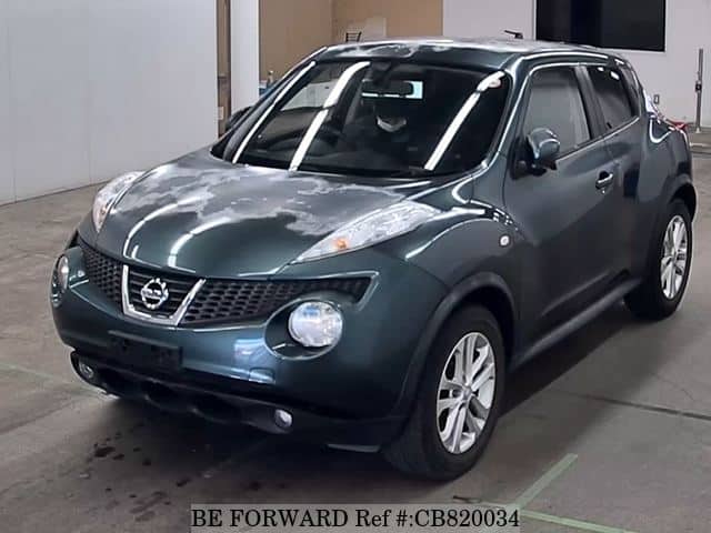 A grey JDM sports car speeding down a highway at night.