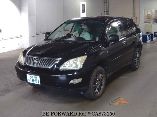 A grey JDM sports car speeding down a highway at night.