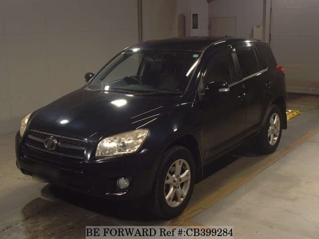A grey JDM sports car speeding down a highway at night.