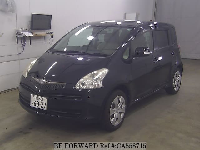 A grey JDM sports car speeding down a highway at night.