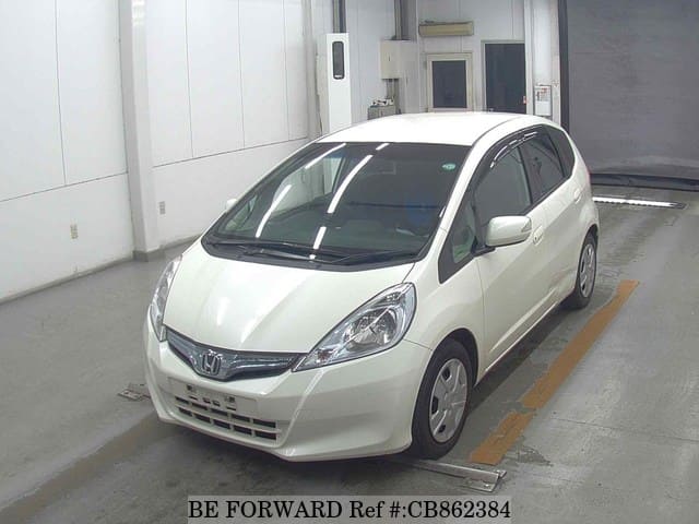 A grey JDM sports car speeding down a highway at night.