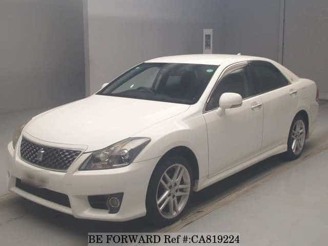 A grey JDM sports car speeding down a highway at night.
