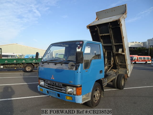 A grey JDM sports car speeding down a highway at night.