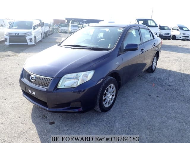 A grey JDM sports car speeding down a highway at night.