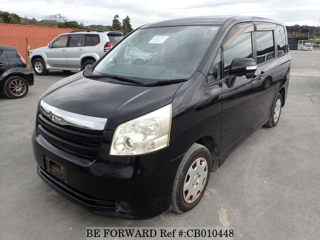 A grey JDM sports car speeding down a highway at night.