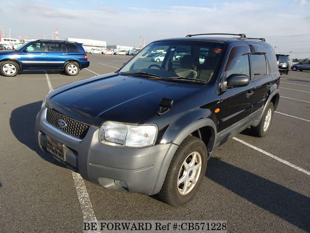 A grey JDM sports car speeding down a highway at night.