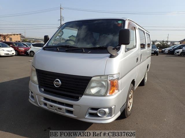 A grey JDM sports car speeding down a highway at night.