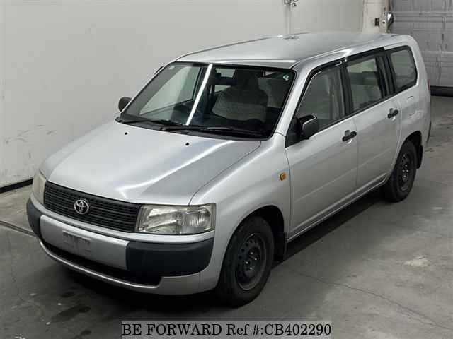 A grey JDM sports car speeding down a highway at night.