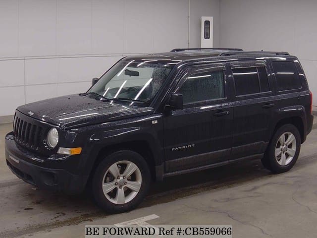 A grey JDM sports car speeding down a highway at night.