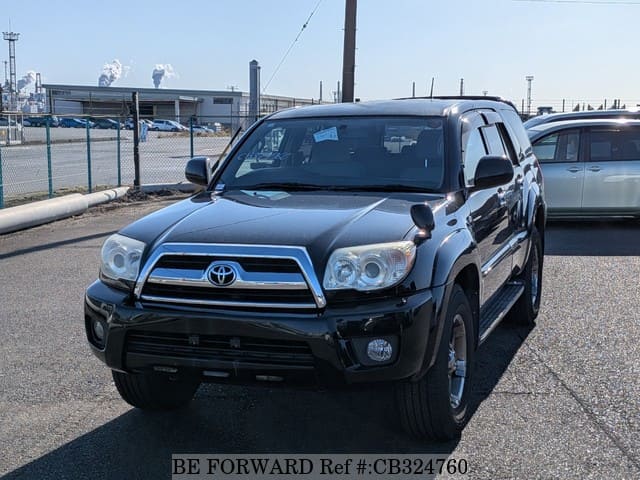 A grey JDM sports car speeding down a highway at night.