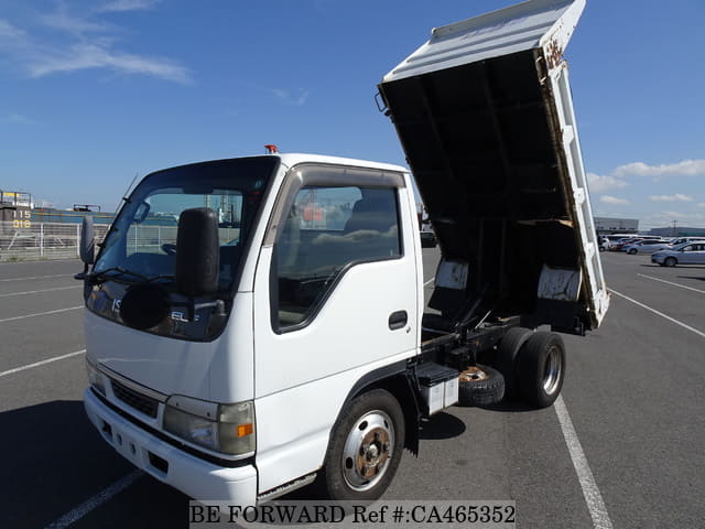 A grey JDM sports car speeding down a highway at night.