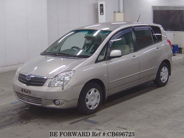 A grey JDM sports car speeding down a highway at night.