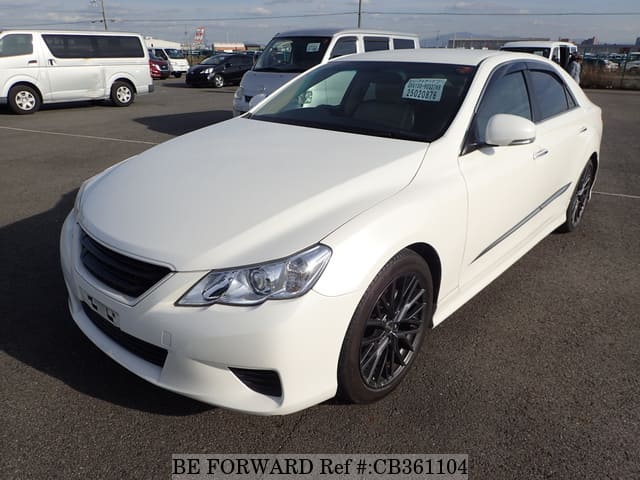A grey JDM sports car speeding down a highway at night.