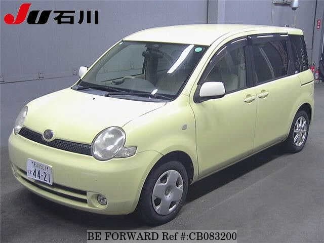 A grey JDM sports car speeding down a highway at night.