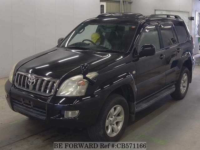 A grey JDM sports car speeding down a highway at night.